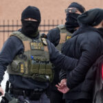 Members of U.S. Immigration and Customs Enforcement (ICE) conduct raids in Minneapolis